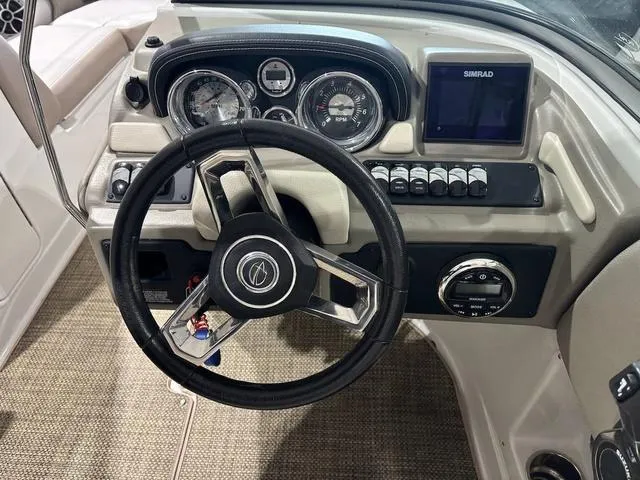 Slide: The Image of 2019 Crownline E 215 XS boat dashboard with steering wheel and gauges. - 8