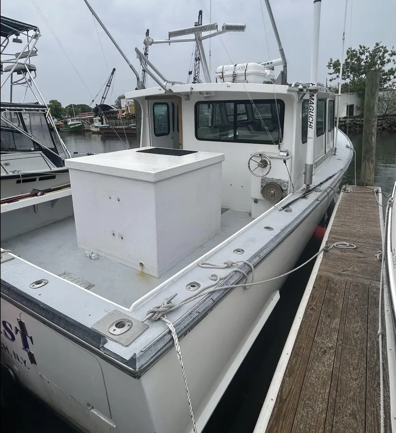 Slide: The Image of 1998 Northern Bay Pilothouse 36 docked, showcasing spacious deck and pilothouse design. - 1