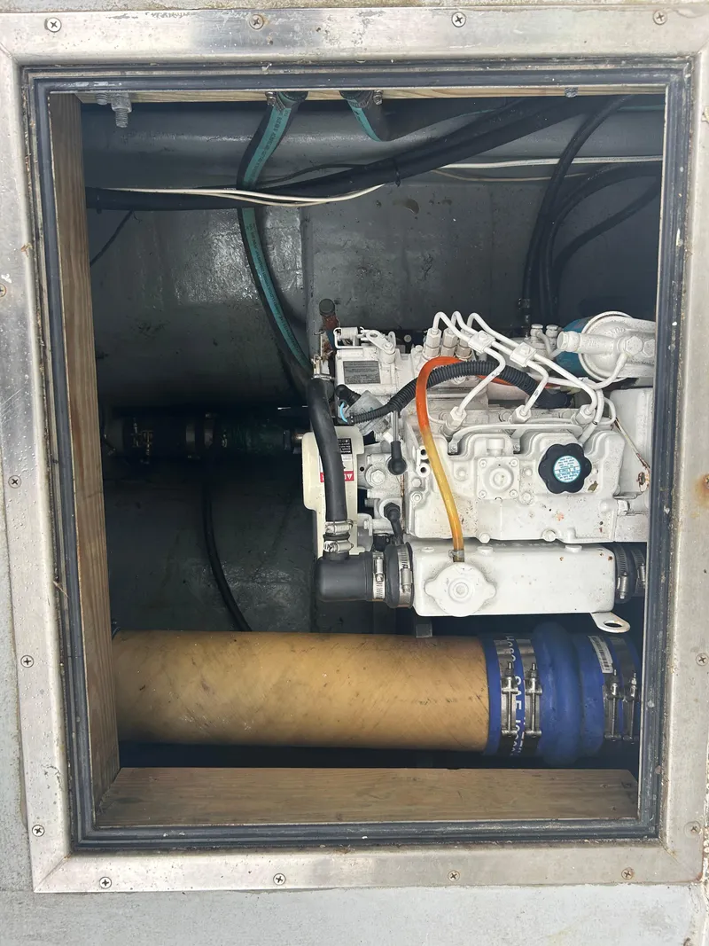 Slide: The Image of Engine compartment of a 1998 Northern Bay Pilothouse 36, showcasing mechanical components. - 15