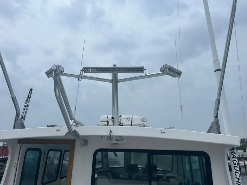 Slide: The Image of 1998 Northern Bay Pilothouse 36 with radar and antennas under cloudy sky. - 4
