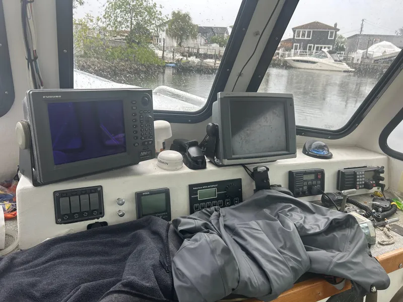 Slide: The Image of Pilothouse interior of 1998 Northern Bay Pilothouse 36 with navigation equipment and waterfront view. - 7