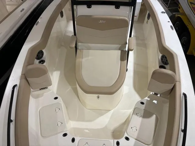 Slide: The Image of 2025 Scout 215 XSF boat interior with beige seating and storage compartments. - 11