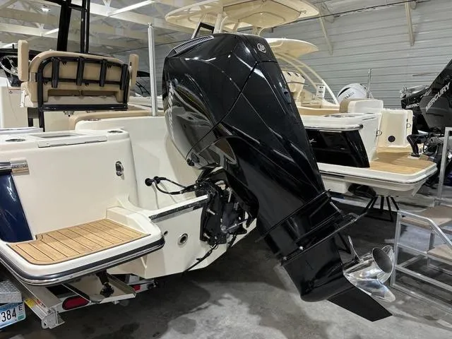 Slide: The Image of 2025 Scout 215 XSF boat with powerful outboard motor in showroom. - 12