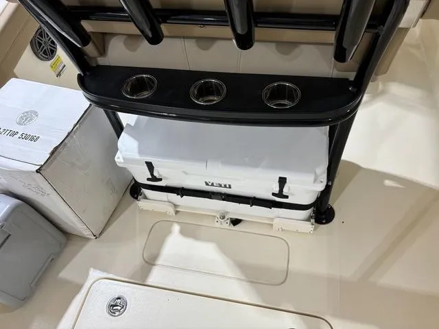 Slide: The Image of 2025 Scout 215 XSF boat interior with cooler and rod holders. - 4