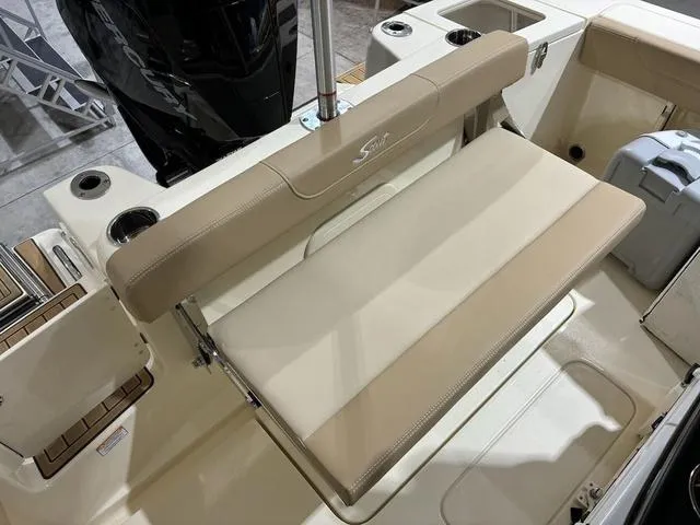 Slide: The Image of 2025 Scout 215 XSF boat with beige seating and cup holders. - 6