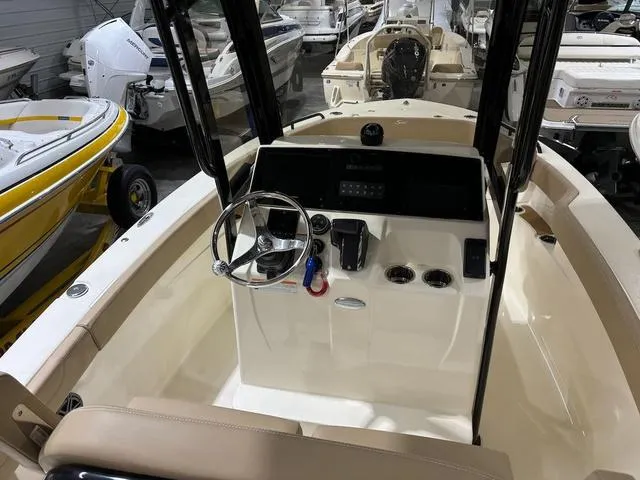 Slide: The Image of 2025 Scout 215 XSF boat interior with steering wheel and control panel. - 7