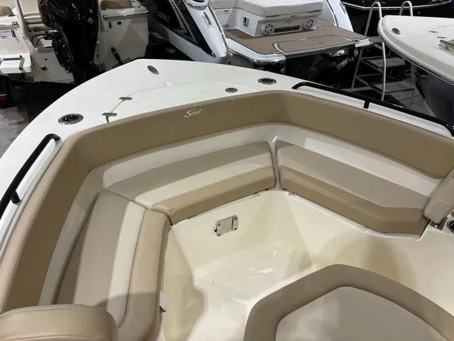 Slide: The Image of 2025 Scout 215 XSF boat interior with beige seating and sleek design. - 9