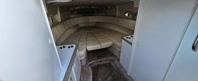 Slide: The Image of 1998 Formula Boats 330 SS cabin interior with beige seating and storage compartments. - 10