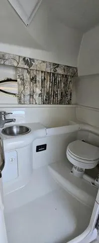 Slide: The Image of 1998 Formula Boats 330 SS bathroom interior with sink and toilet. - 12