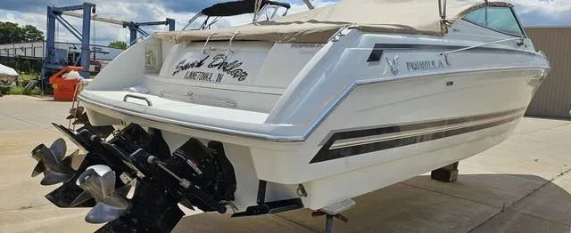 Slide: The Image of 1998 Formula Boats 330 SS, white exterior, docked on land, featuring dual propellers. - 4