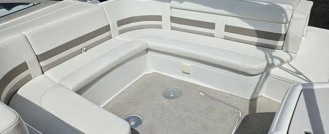 Slide: The Image of 1998 Formula Boats 330 SS interior with white and beige seating, spacious layout. - 5