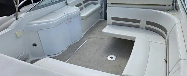 Slide: The Image of 1998 Formula Boats 330 SS interior with white seating and carpeted floor. - 6