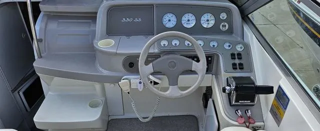 Slide: The Image of 1998 Formula Boats 330 SS dashboard with steering wheel and gauges. - 8