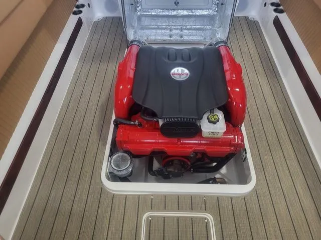 Slide: The Image of 2024 Thoroughbred u23i engine with red accents on a boat deck. - 10