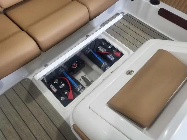 Slide: The Image of 2024 Thoroughbred u23i boat interior showing battery compartment and seating area. - 11