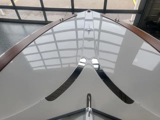 Slide: The Image of 2024 Thoroughbred u23i boat with sleek, modern design and polished finish in showroom. - 16