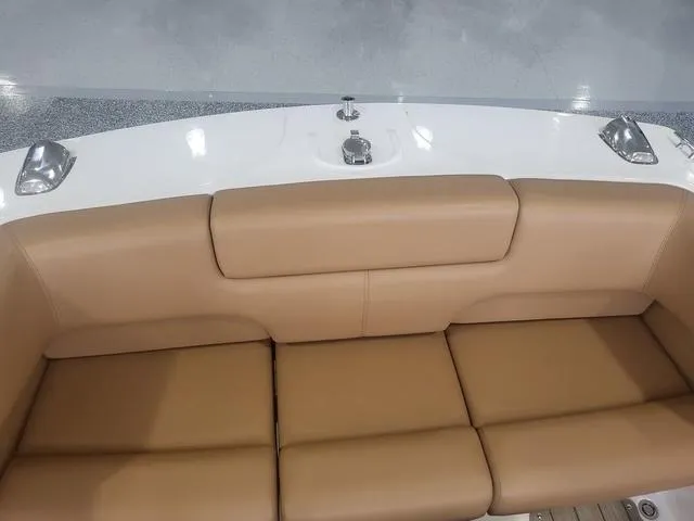 Slide: The Image of 2024 Thoroughbred u23i boat with tan leather seating and sleek design. - 18