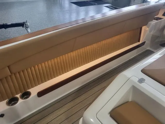 Slide: The Image of Luxurious interior of 2024 Thoroughbred u23i boat with elegant seating and cup holders. - 19