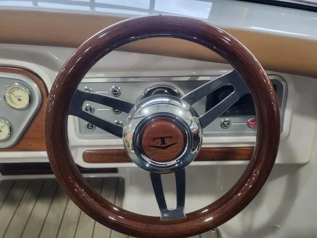 Slide: The Image of Steering wheel of 2024 Thoroughbred u23i with wood and chrome accents. - 22