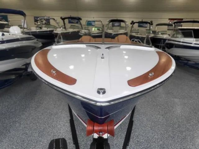 Slide: The Image of 2024 Thoroughbred u23i boat displayed in showroom, featuring sleek design and modern finishes. - 28