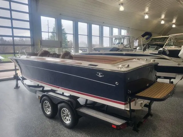 Slide: The Image of 2024 Thoroughbred u23i boat on trailer in showroom, featuring sleek design and modern amenities. - 3