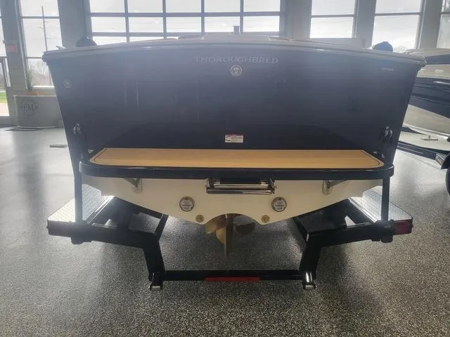 Slide: The Image of 2024 Thoroughbred u23i boat on trailer in showroom, rear view. - 4