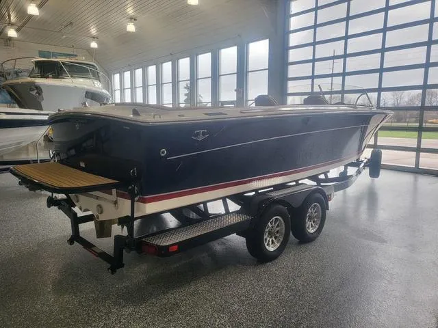 Slide: The Image of 2024 Thoroughbred u23i boat on trailer in showroom with large windows. - 5