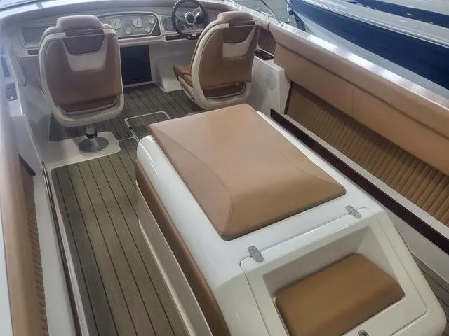 Slide: The Image of 2024 Thoroughbred u23i boat interior with brown leather seats and modern dashboard. - 6