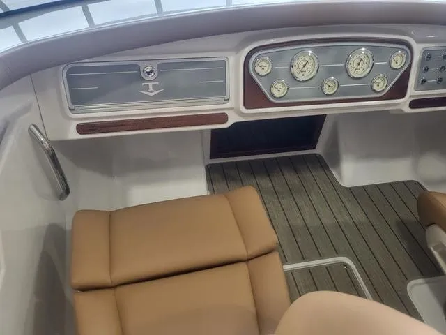 Slide: The Image of 2024 Thoroughbred u23i boat interior with classic dashboard and tan seating. - 8