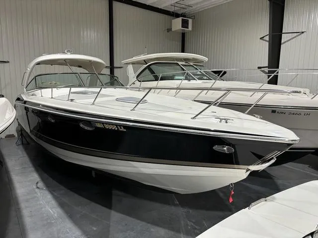 Slide: The Image of 2015 Formula Boats 400 Super Sport in a showroom, sleek design, black and white exterior. - 1