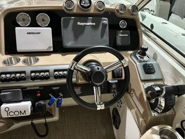 Slide: The Image of 2015 Formula Boats 400 Super Sport dashboard with steering wheel and navigation controls. - 10