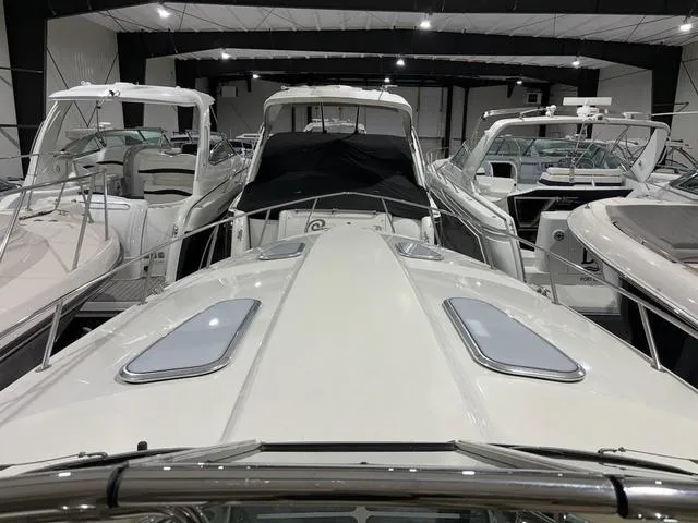 Slide: The Image of 2015 Formula Boats 400 Super Sport in a showroom, surrounded by other luxury boats. - 11
