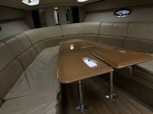 Slide: The Image of Interior of 2015 Formula Boats 400 Super Sport with beige seating and wooden table. - 14