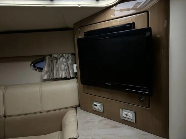 Slide: The Image of Interior of 2015 Formula Boats 400 Super Sport with TV and beige seating. - 15