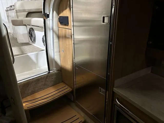 Slide: The Image of Interior of 2015 Formula Boats 400 Super Sport, featuring sleek wood and stainless steel finishes. - 19