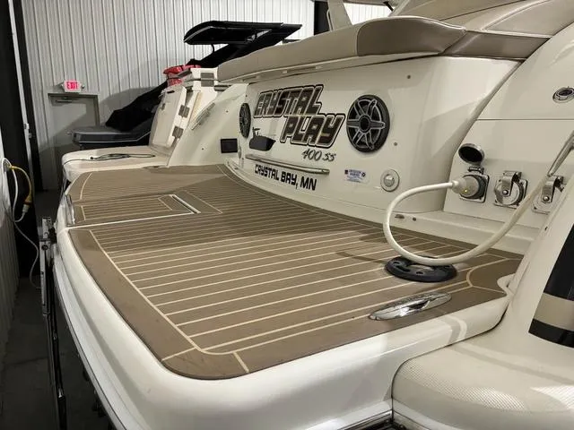 Slide: The Image of 2015 Formula Boats 400 Super Sport with teak deck and audio system in a marina setting. - 2