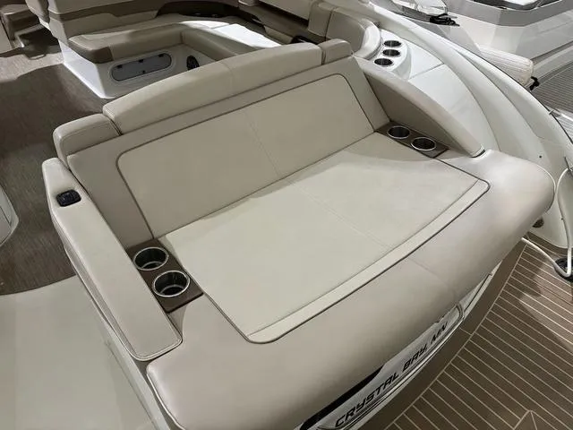 Slide: The Image of 2015 Formula Boats 400 Super Sport interior with beige seating and cup holders. - 4