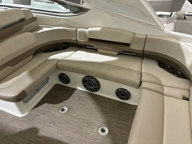 Slide: The Image of 2015 Formula Boats 400 Super Sport interior with beige seating and built-in speakers. - 6