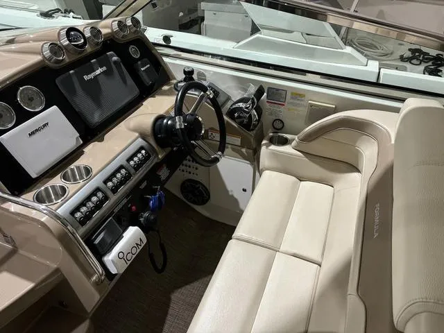 Slide: The Image of Interior of 2015 Formula Boats 400 Super Sport with beige seating and advanced dashboard controls. - 9