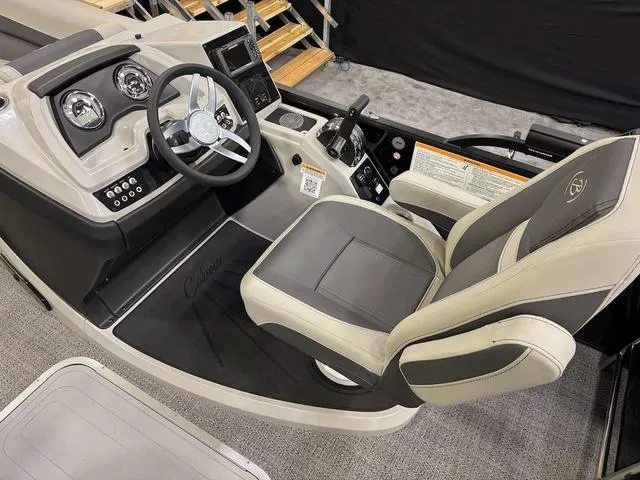 Slide: The Image of 2025 Barletta Boats C22M helm with modern controls and comfortable captain's chair. - 6