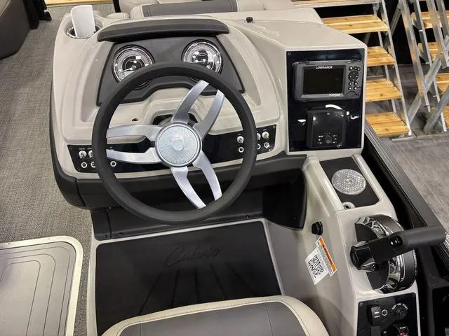 Slide: The Image of 2025 Barletta Boats C22M dashboard with steering wheel and control panel. - 7