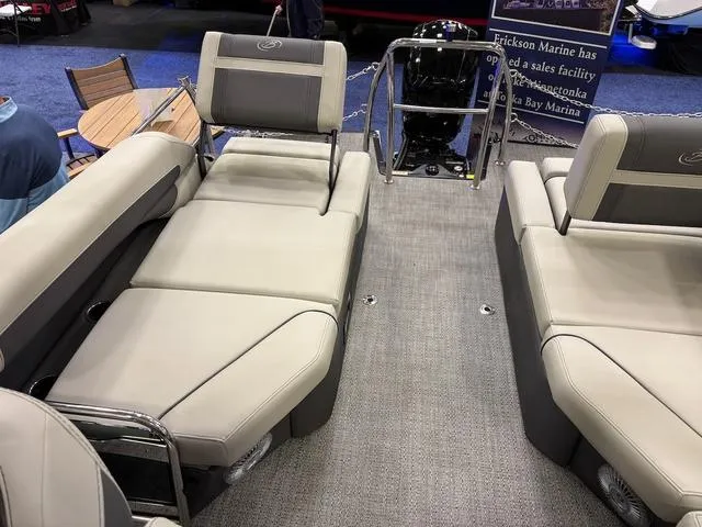 Slide: The Image of 2025 Barletta Boats C22M interior with beige seating and carpeted flooring. - 8