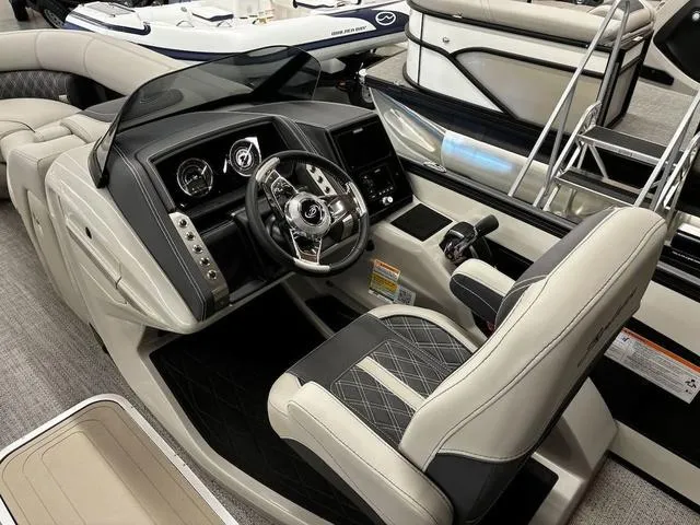 Slide: The Image of 2024 Barletta Lusso L23UC boat interior with modern steering and luxurious seating. - 4