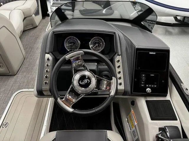 Slide: The Image of 2024 Barletta Lusso L23UC boat dashboard with steering wheel and control panel. - 5
