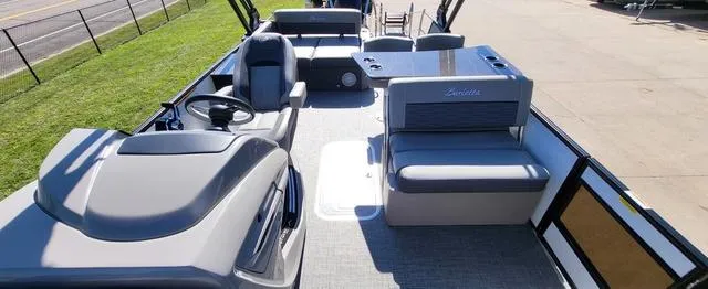 Slide: The Image of 2024 Barletta Corsa 25UEA boat interior with modern seating and steering area. - 6