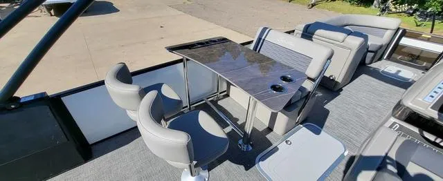 Slide: The Image of 2024 Barletta Corsa 25UEA boat interior with seating and table setup. - 9