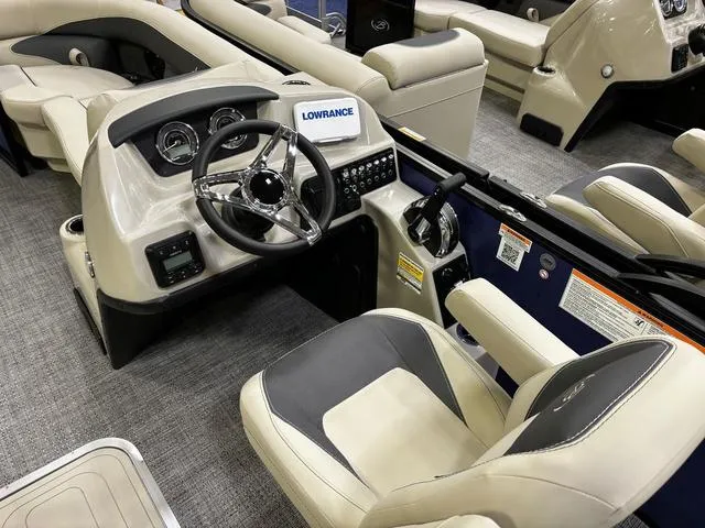 Slide: The Image of 2024 Barletta Aria A22UC boat interior with steering wheel and seating. - 4