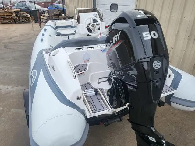 Slide: The Image of 2024 Walker Bay Venture 13 boat with Mercury 50 engine, docked outdoors. - 3