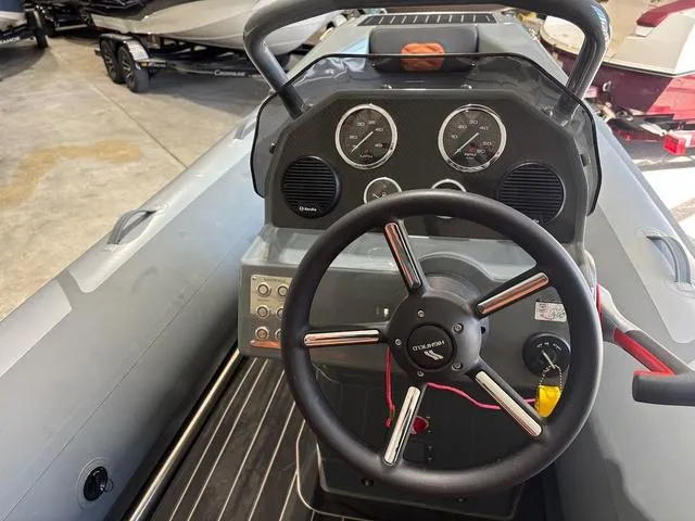 Slide: The Image of 2023 Highfield Sport 390 boat dashboard with steering wheel and gauges. - 5