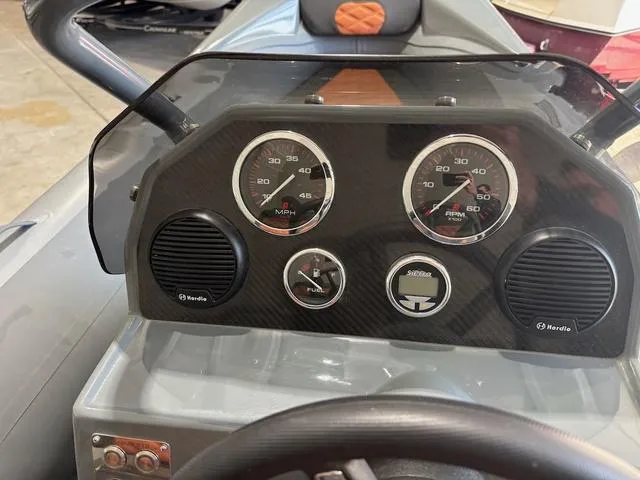 Slide: The Image of Dashboard of 2023 Highfield Sport 390 boat with speedometer and fuel gauge. - 6